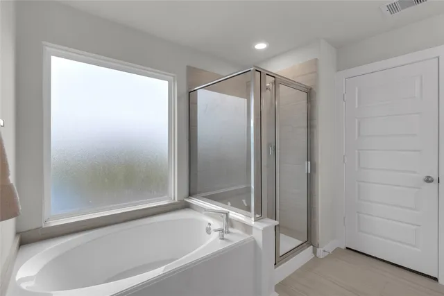 a bathroom with a bathtub and a shower