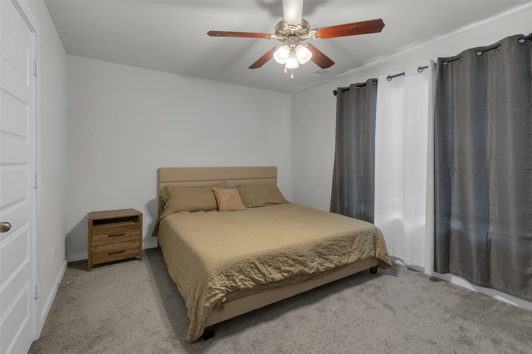 2314 Village Side Trail Rosenberg, TX 77471 - Photo 27 of 31 a bedroom with a bed and a chandelier