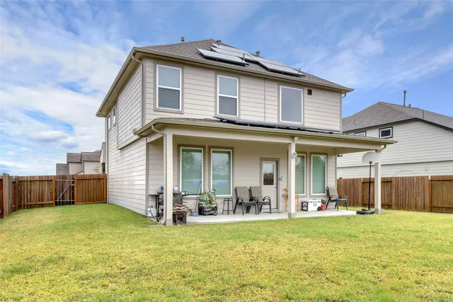 a backyard of a house with table and chairs