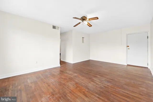 a view of a room with wooden floor