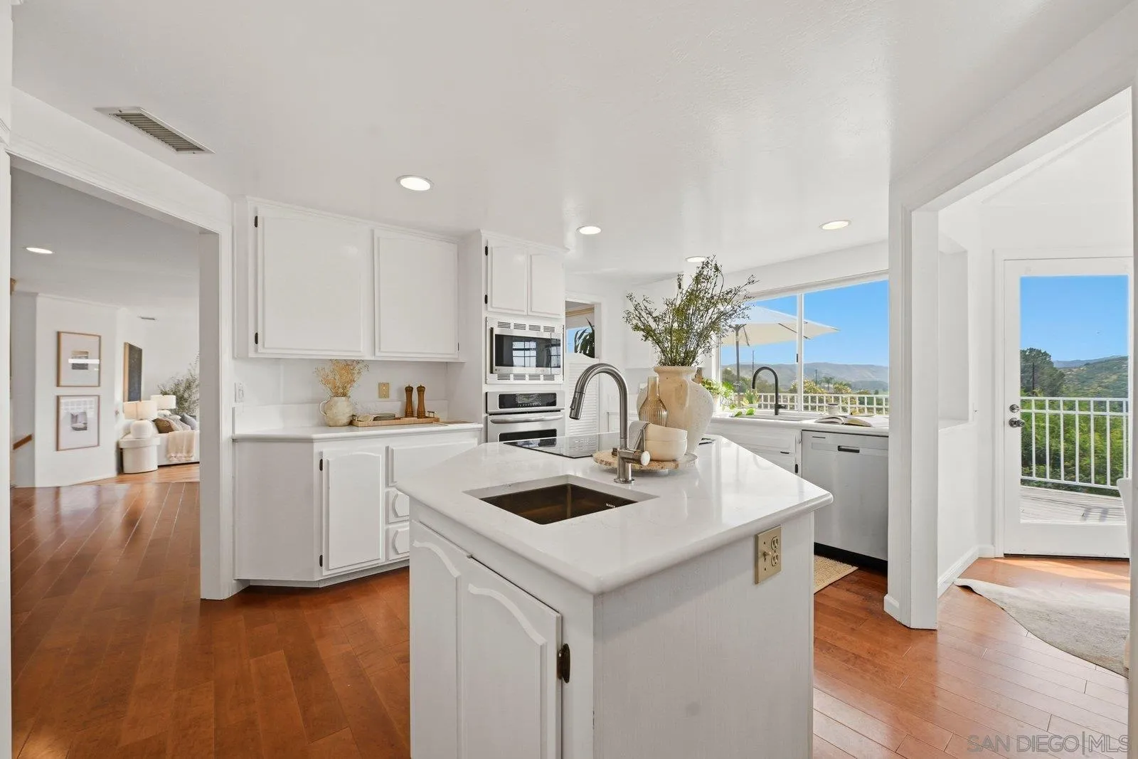3132 Don Rolando Escondido, CA 92025 - Photo 13 of 56 a kitchen with a sink a stove and cabinets