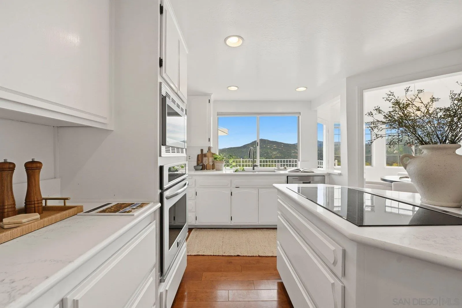 3132 Don Rolando Escondido, CA 92025 - Photo 15 of 56 a kitchen with stainless steel appliances granite countertop a sink and a stove