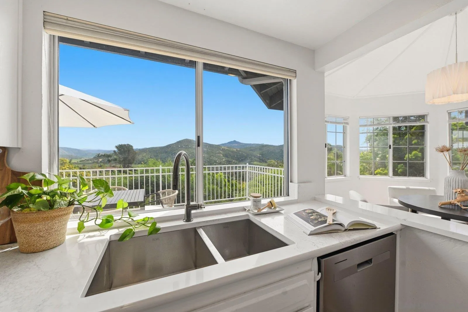 3132 Don Rolando Escondido, CA 92025 - Photo 16 of 56 a view of a sink and a potted plant next to a window