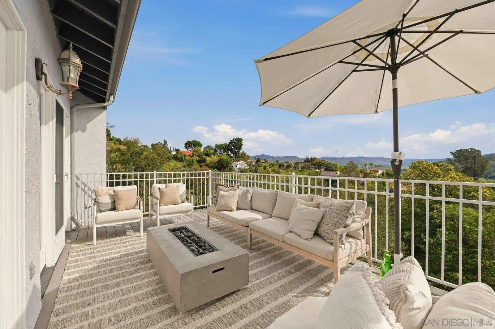 3132 Don Rolando Escondido, CA 92025 - Photo 34 of 56 a view of a roof deck with couches under an umbrella