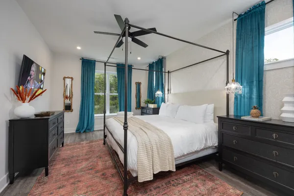 a bedroom with a bed and a flat screen tv