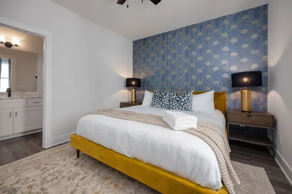 a bedroom with a bed and a view of kitchen
