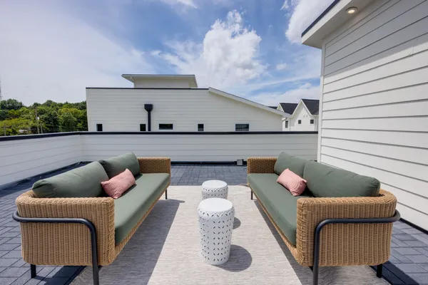 a balcony with furniture and a potted plant