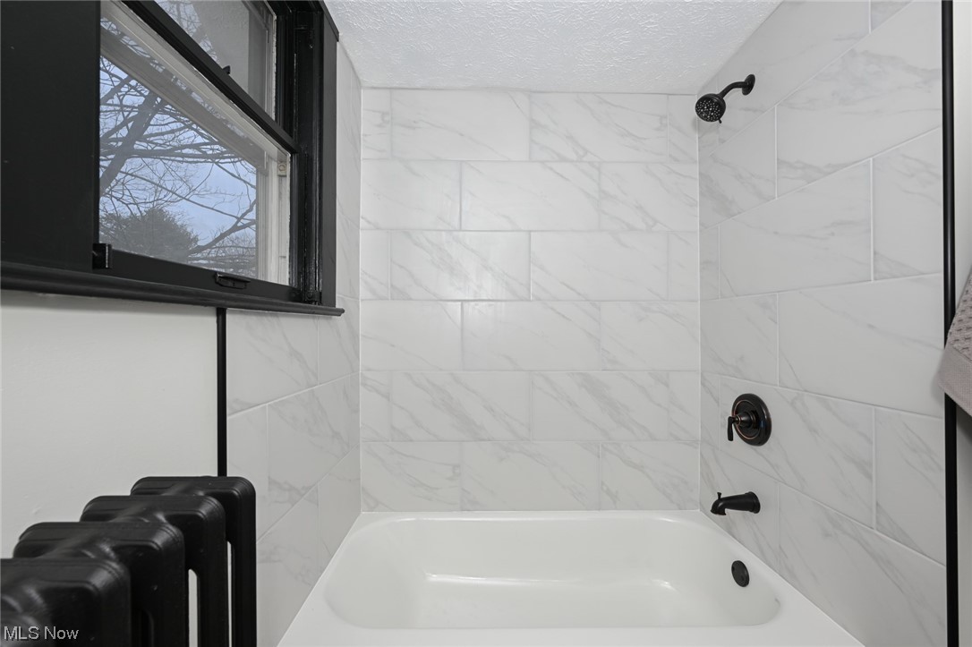 232 Randolph Road Mogadore, OH 44260 - Photo 27 of 35 Bathroom featuring tiled shower / bath combo and a textured ceiling
