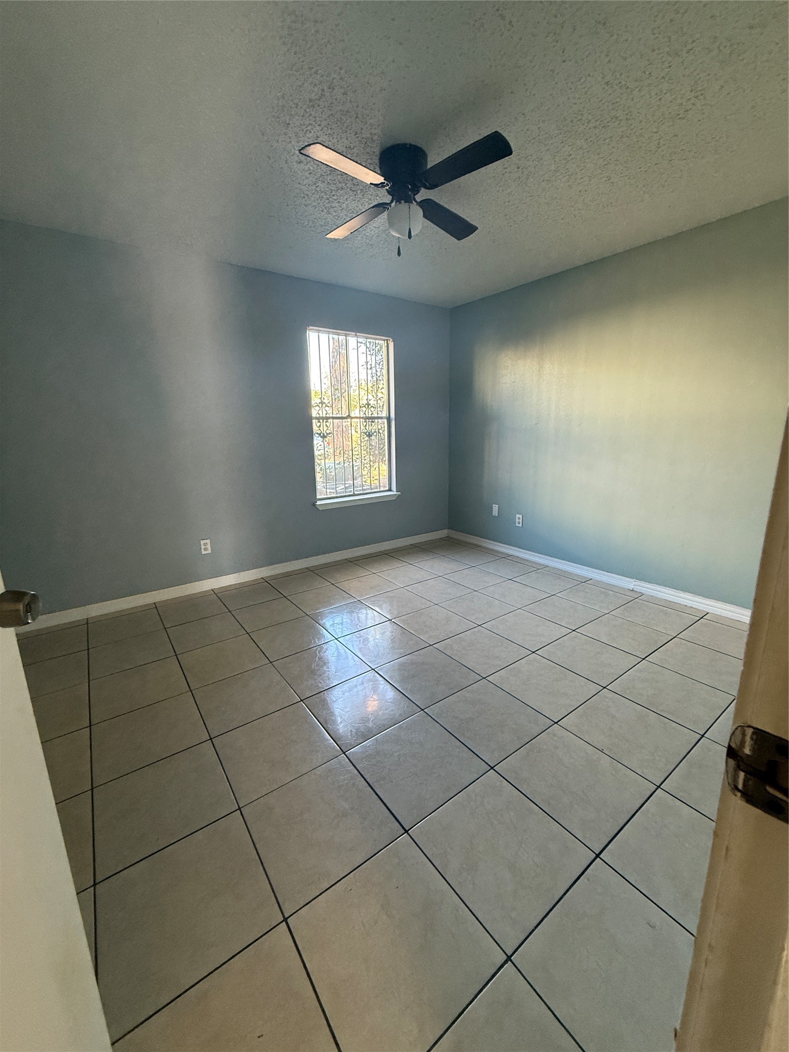7402 Alabonson Road, Unit 407 Houston, TX 77088 - Photo 8 of 14 a view of an empty room and a window