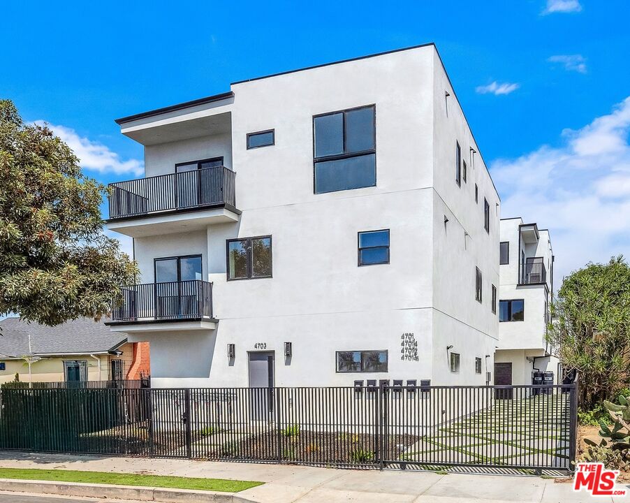 a view of a white building among the street