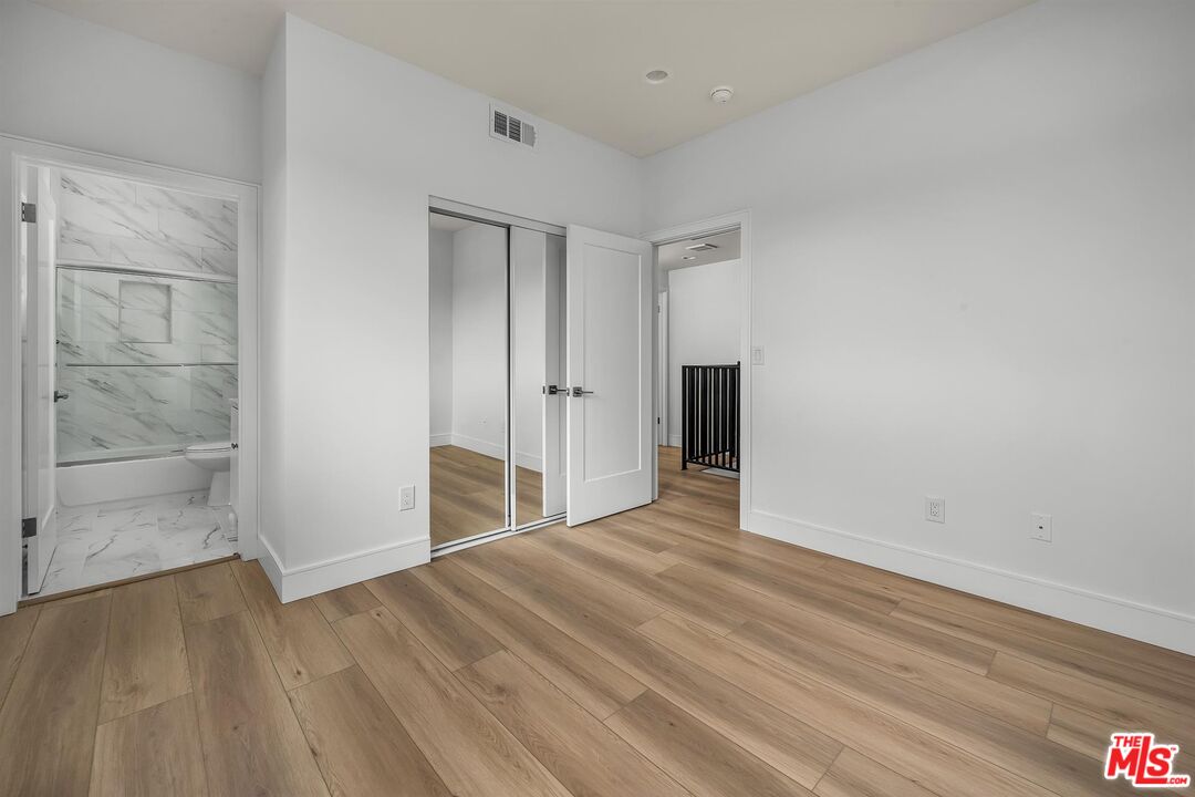 4703 Saturn Street Los Angeles, CA 90019 - Photo 24 of 37 a view of an empty room with wooden floor