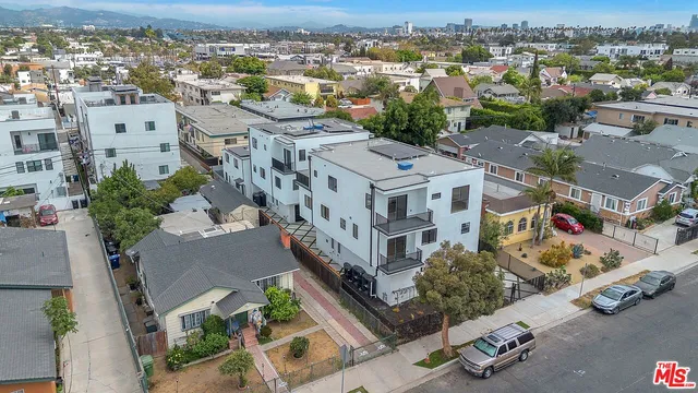 an aerial view of residential houses with outdoor space