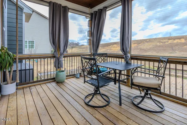 a view of a chairs on wooden deck