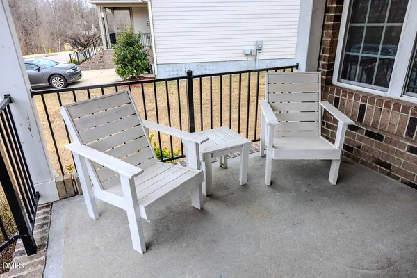 a roof deck with table and chairs