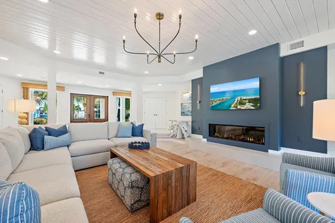 a living room with furniture a rug and a chandelier