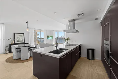 a living room with glass windows and glass door
