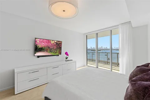 a spacious bedroom with a bed and a window