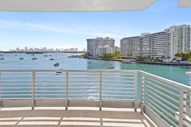 a view of a lake with tall buildings