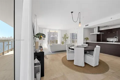 a dining room with furniture a window and kitchen view