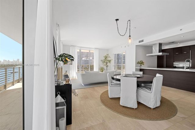a dining room with furniture a window and kitchen view