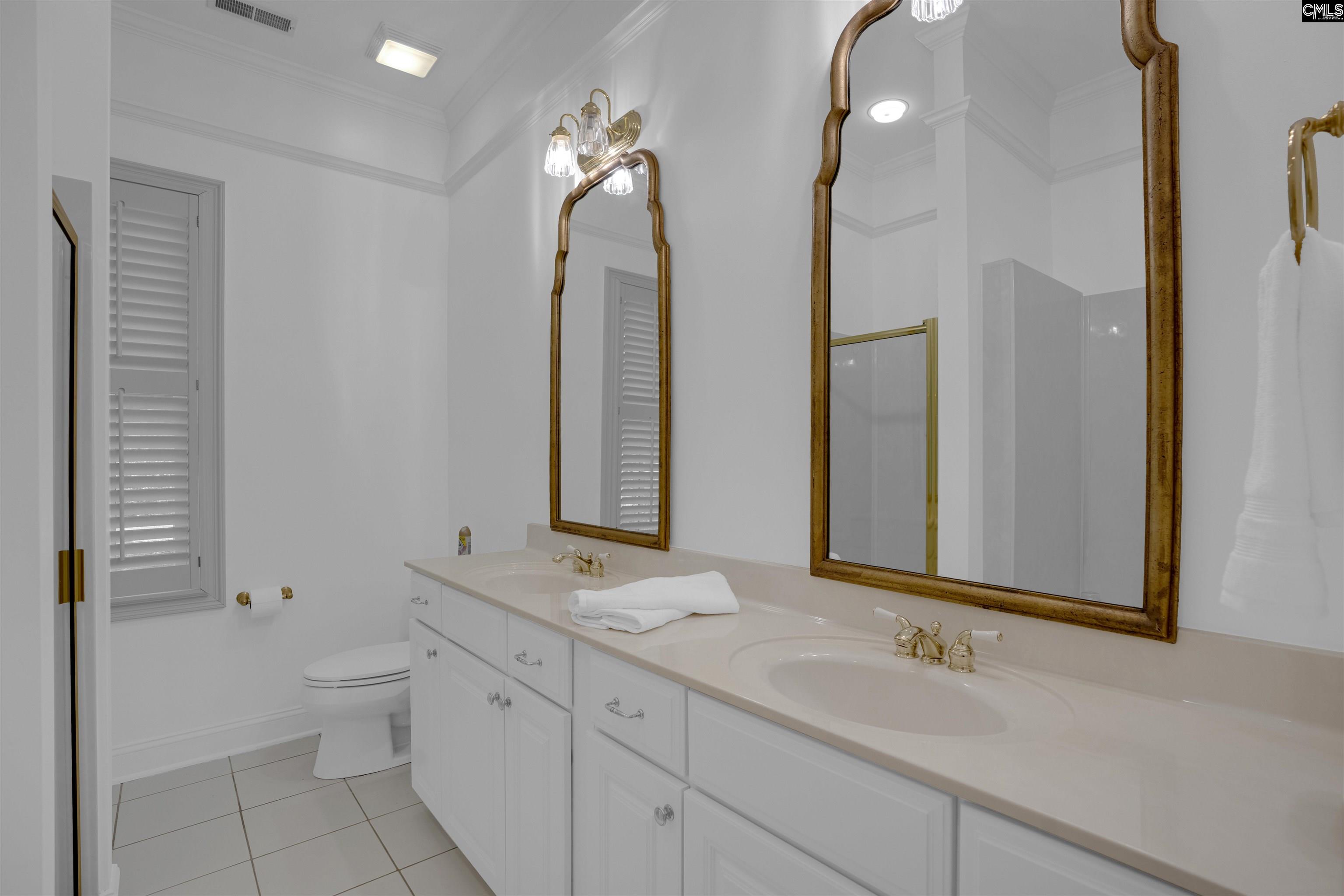 1101 Ellett Road Chapin, SC 29036 - Photo 17 of 24 a bathroom with a double vanity sink toilet and shower