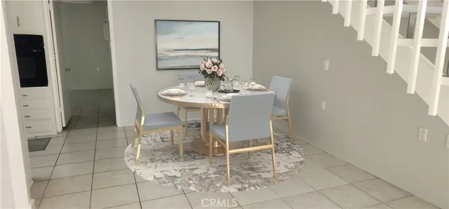 a dining room with furniture and a mirror