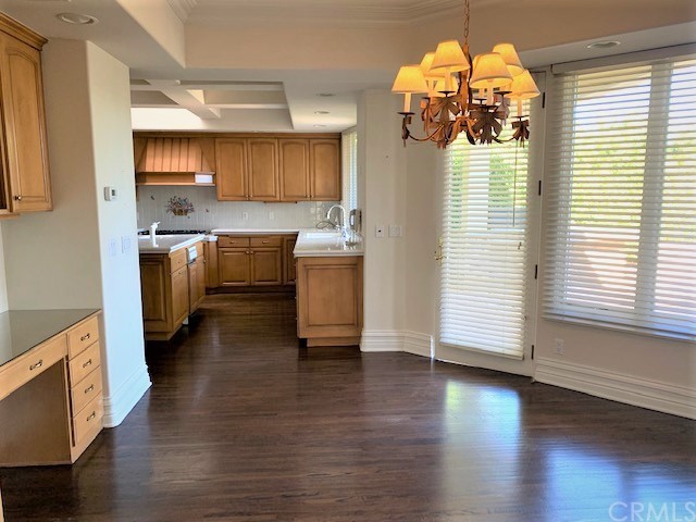 3930 Coral Place Calabasas, CA 91302 - Photo 11 of 50 a kitchen with a chandelier stainless steel appliances and wooden floor