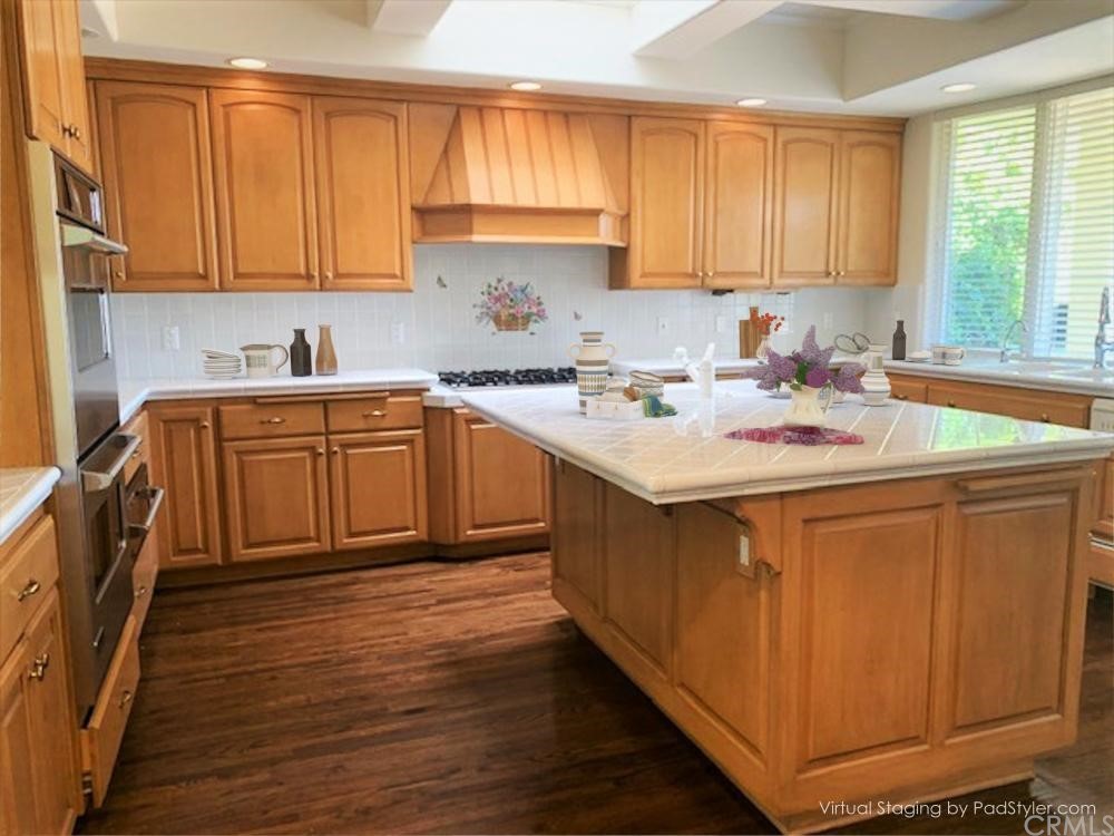 3930 Coral Place Calabasas, CA 91302 - Photo 12 of 50 a kitchen with stainless steel appliances granite countertop a sink stove and cabinets