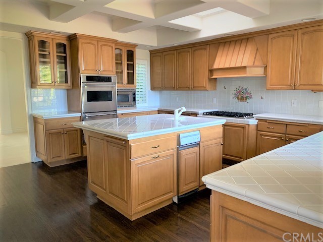3930 Coral Place Calabasas, CA 91302 - Photo 13 of 50 a kitchen with stainless steel appliances granite countertop a sink stove and cabinets