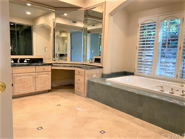 3930 Coral Place Calabasas, CA 91302 - Photo 18 of 50 a large bathroom with a large tub sink and vanity