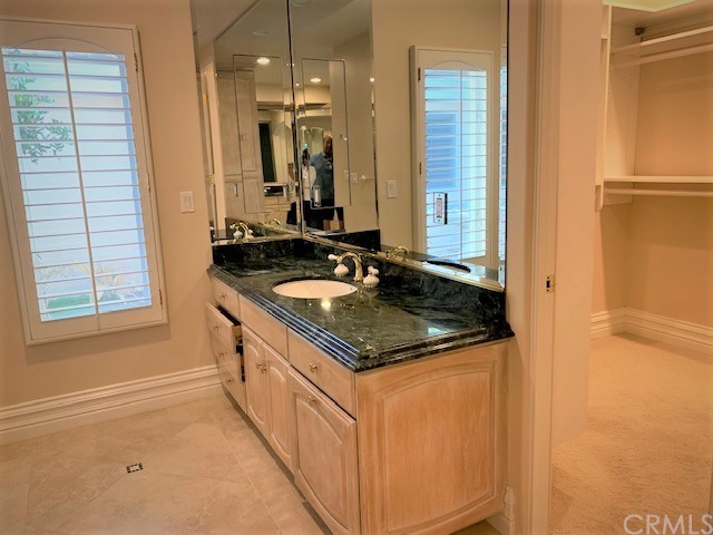 3930 Coral Place Calabasas, CA 91302 - Photo 20 of 50 a bathroom with a granite countertop sink and a mirror