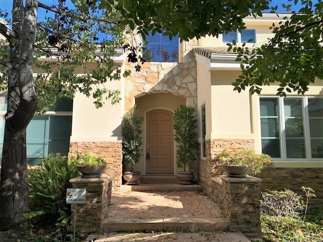 3930 Coral Place Calabasas, CA 91302 - Photo 3 of 50 a front view of a house with garden