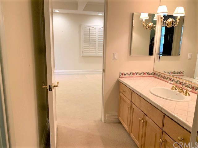 3930 Coral Place Calabasas, CA 91302 - Photo 33 of 50 a bathroom with a double vanity sink and a mirror