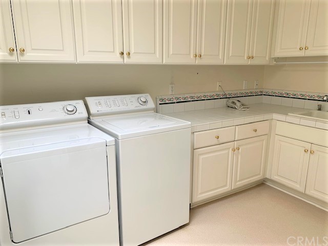 3930 Coral Place Calabasas, CA 91302 - Photo 37 of 50 a utility room with dryer and washer