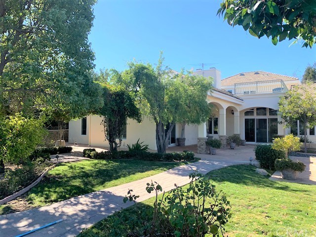 3930 Coral Place Calabasas, CA 91302 - Photo 40 of 50 a front view of a house with garden