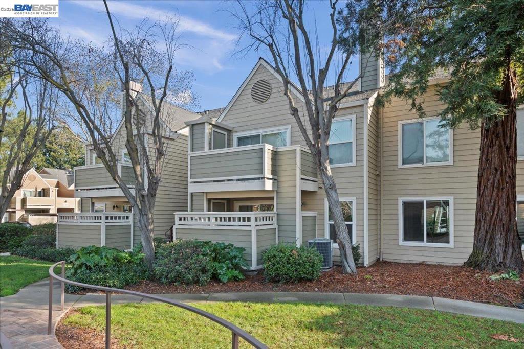 a front view of a house with a yard balcony