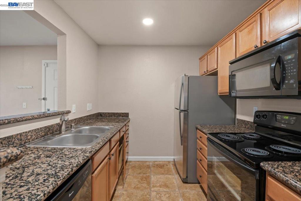 215 Reflections Drive San Ramon, CA 94583 - Photo 7 of 17 a kitchen that has a sink wooden cabinets and stainless steel appliances