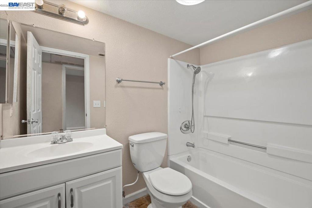 215 Reflections Drive San Ramon, CA 94583 - Photo 10 of 17 a bathroom with a toilet a sink and a bathtub