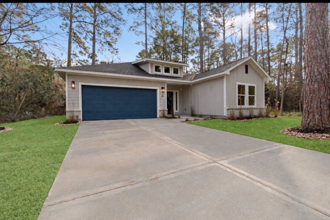 a front view of a house with a garden and trees