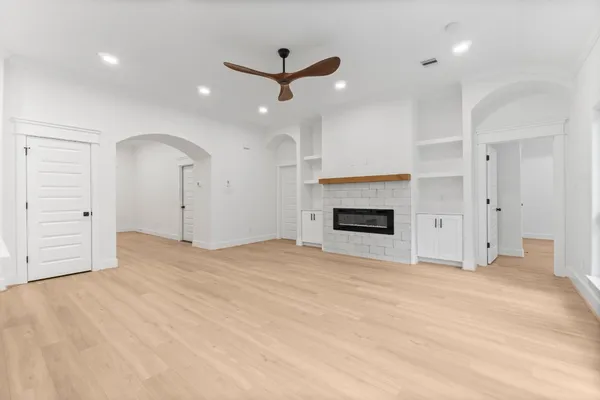 an empty room with closet and a fireplace