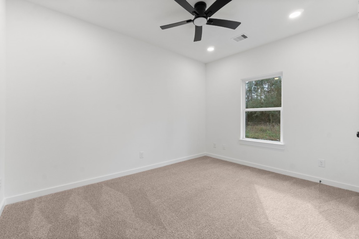 34 Cottonwood Trinity, TX 75862 - Photo 16 of 44 an empty room with a window and a fan