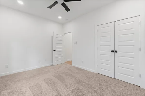 an empty room with closet area