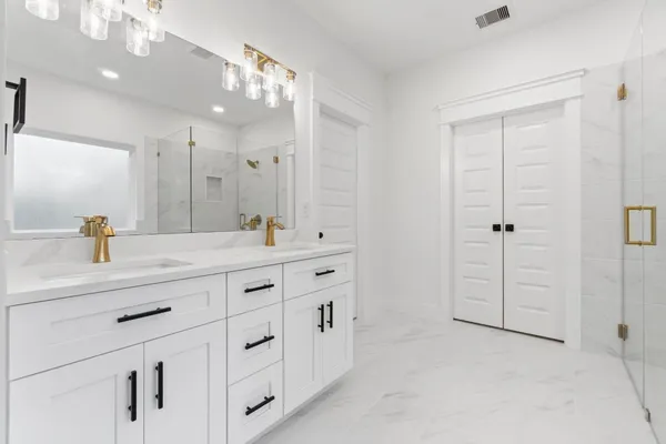 a bathroom with a double vanity sink and mirror
