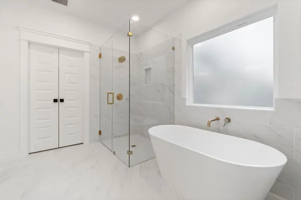 a white bath tub sitting next to a white toilet