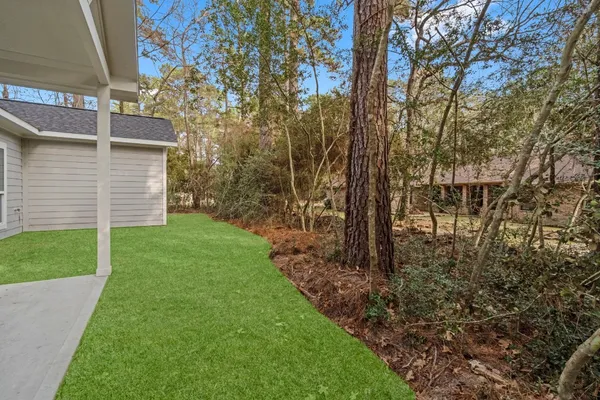 a view of a backyard with large trees