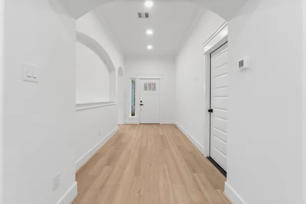 a view of a room with wooden floor and white walls