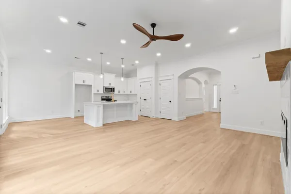 a view of a kitchen with a sink and a refrigerator