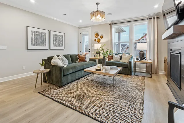 a living room with furniture wooden floor and a flat screen tv