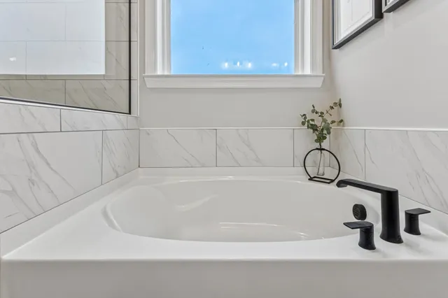 a white bath tub sitting next to a white sink