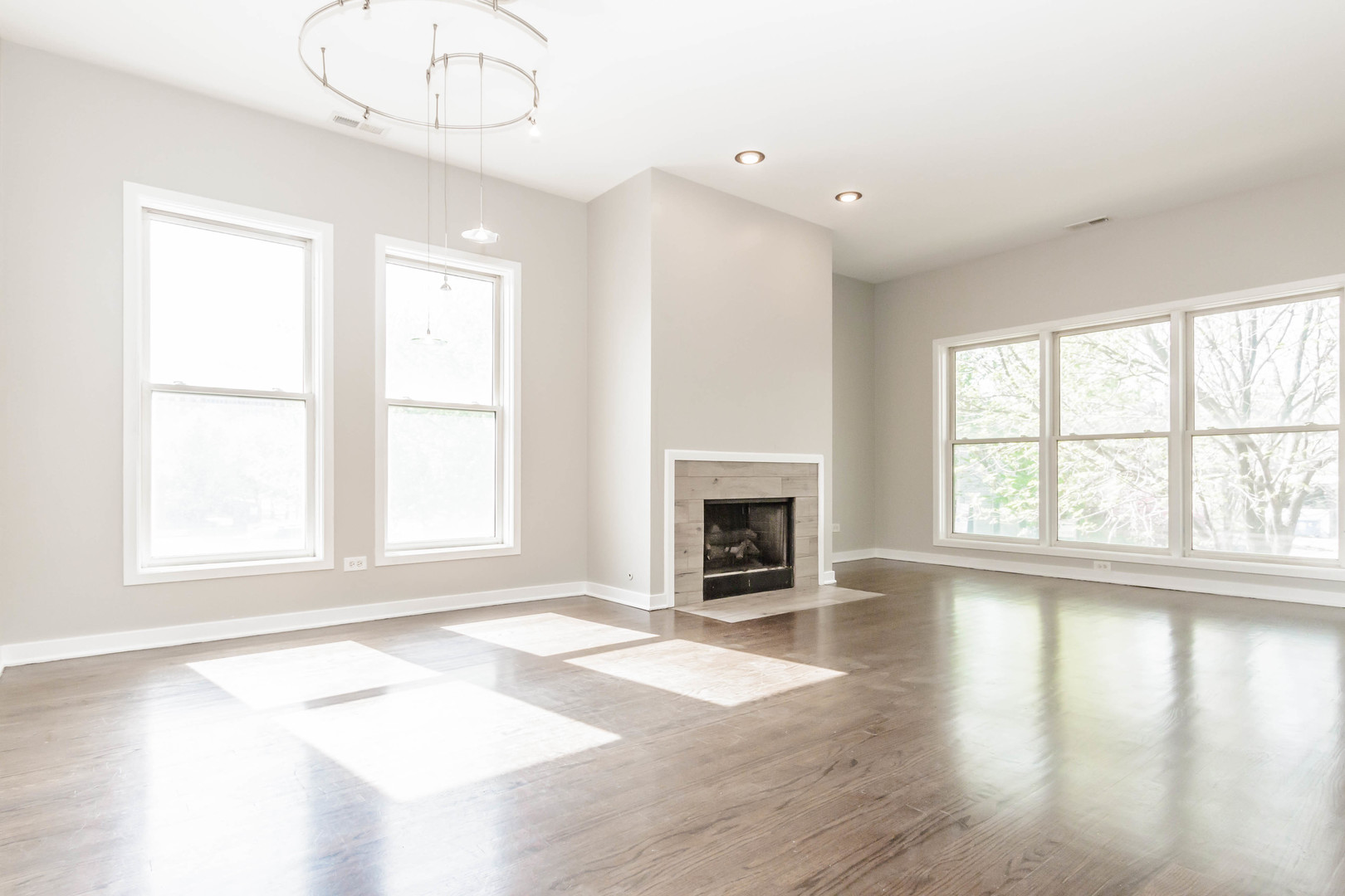 1443 West Fillmore Street Chicago, IL 60607 - Photo 17 of 37 an empty room with wooden floor fireplace and windows